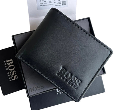 Close-up of debossed BOSS Hugo Boss logo on smooth black leather bifold wallet