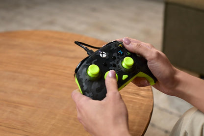 Gamer holding green camo Turtle Beach Rematch Core Xbox controller