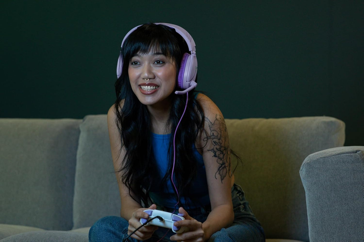 Gamer wearing lavender Turtle Beach Recon 70 headset while playing