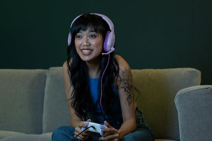 Gamer wearing lavender Turtle Beach Recon 70 headset while playing