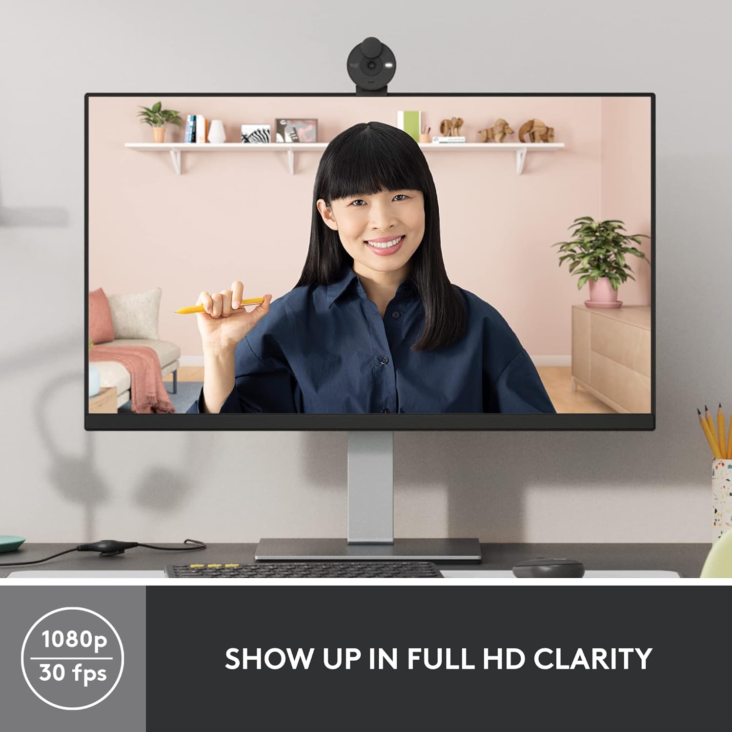 Woman on a video call displayed on a computer monitor with text 'Show up in full HD clarity'.